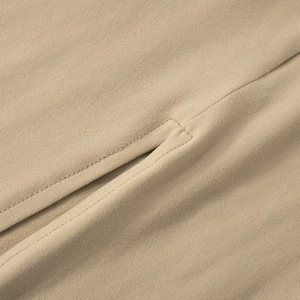 Detailed close-up of side slit seams and fine stitching on khaki knitted dress
