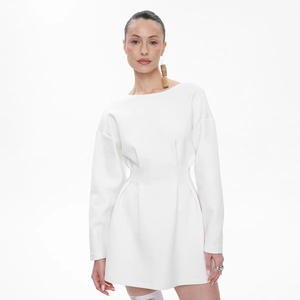 Close-up of waist pleats on white long sleeve dress highlighting elegant waistline detail
