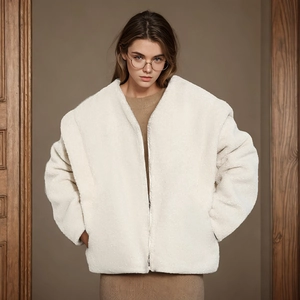 Close-up of fluffy off-white fleece jacket with zipper detail and smooth plush texture