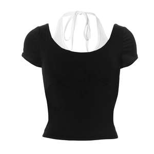 Detail of black faux two-piece crop top with white halter neck strap and slim fit