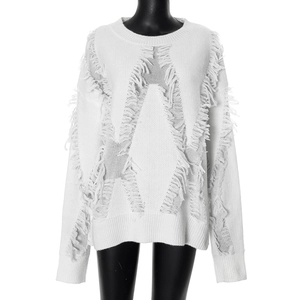 Detail of white star-shaped distressed knit sweater with fringe tassel textures