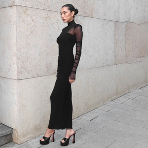 Chic black bodycon maxi dress featuring sheer mesh sleeves and padded shoulders for women