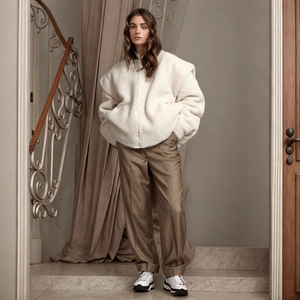 Full view of women's cream fleece zip jacket and khaki straight-leg tailored trousers
