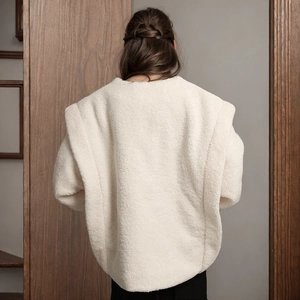 Rear view of a premium cream faux shearling jacket with oversized drop shoulder design
