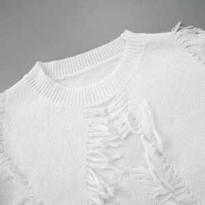Detail of white knit sweater showing distressed ripped texture and fringed hem design