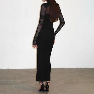 Detail of sheer mesh sleeves and back rushing on a long black bodycon dress