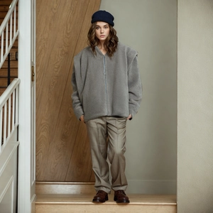 Full-body view of a gray sherpa fleece jacket with a relaxed fit and zipper closure