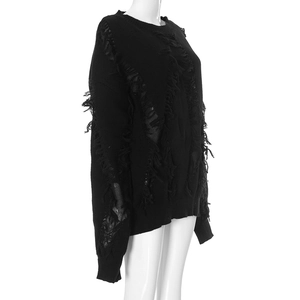 Detail of black knitted sweater with distressed fringe and ripped texture style