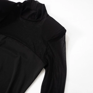Detail view of black high neck mesh dress with sheer patchwork sleeves and solid bodice