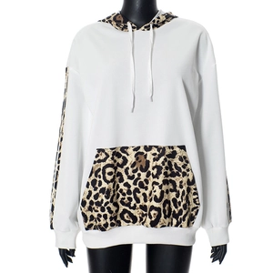 Detail of white hoodie featuring leopard print patchwork on the hood and pocket