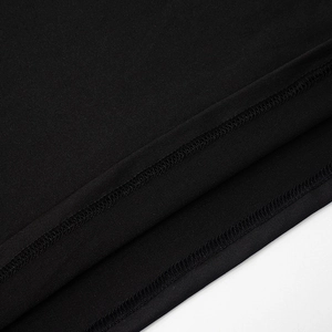 Close-up of high-quality double-stitched hem on a black mesh dress for durability