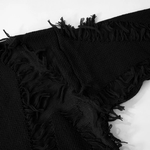 Detailed view of black knitted sweater featuring distressed fringe and mesh patchwork