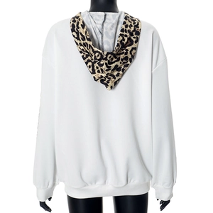 Detail of white oversized hoodie showing leopard print hood and drop shoulder stitching