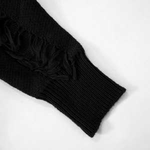 Detail view of black knit sweater sleeve featuring distressed ripped holes and ribbed cuffs
