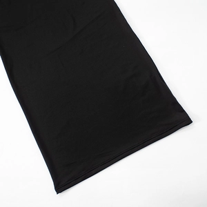 Close-up of double-needle stitching on the hem of a black mesh maxi dress