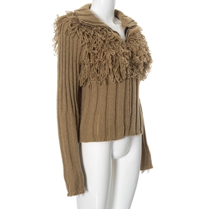Detail view of brown zip-up knit cardigan featuring textured fringe and ribbed fabric