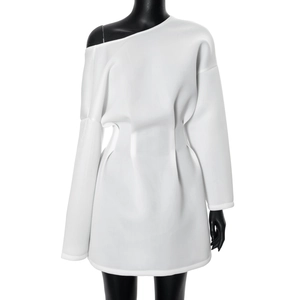 Detail of white long sleeve dress showing asymmetric neckline and pleated waist texture