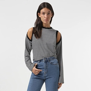 Detail of the chic cut-out shoulder design on a black and white striped casual top