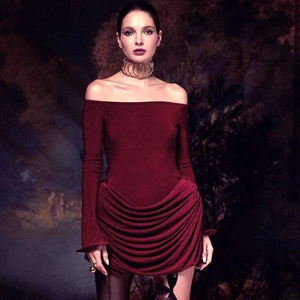 Detail of burgundy off-shoulder mini dress with ruched texture and elegant long sleeves
