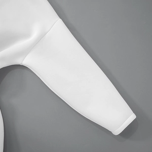 Detail of white long sleeve dress showing thick smooth space cotton fabric and ribbed cuff