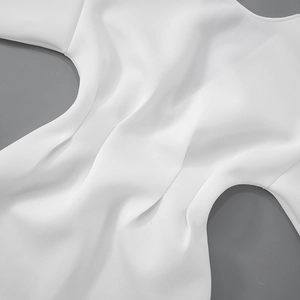 Close-up of premium white fabric texture with elegant drapes and smooth silky finish