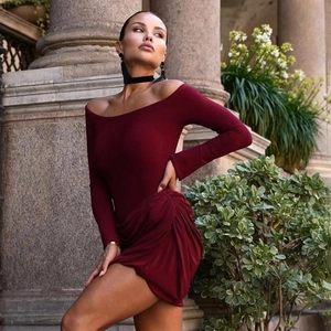 Close-up of the burgundy off-the-shoulder long sleeve dress with ruched skirt detailing