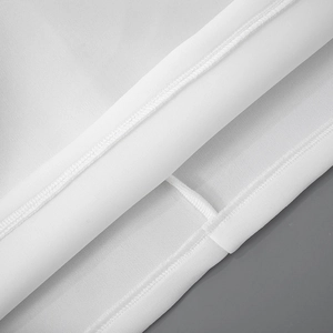 Detailed close-up showing double-needle stitching and neat seams on white cotton dress