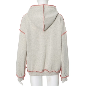 Detailed back view of heather grey hoodie featuring vibrant red contrast stitching details