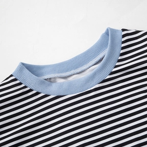 Close-up of the light blue ribbed crew neck and black and white striped fabric detail