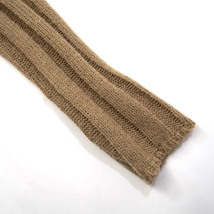 Detail of brown ribbed knit fabric texture on long sleeve slim cardigan top