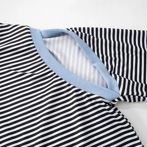 Detail of striped long sleeve top featuring a light blue ribbed crew neck and knit texture