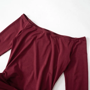 Detail view of the elegant off-shoulder neckline and smooth burgundy fabric of the dress