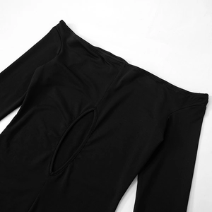 Detail of black off-the-shoulder neckline with elegant oval cut-out and fine stitching
