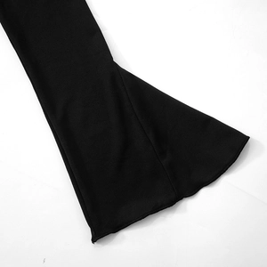 Detail of elegant black off-shoulder dress featuring flared bell sleeves and premium fabric