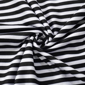 Close-up of black and white striped knit fabric texture with fine vertical ribbed pattern