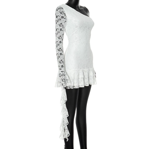 Detail of white lace dress with one-shoulder design and ruffled hemline textures