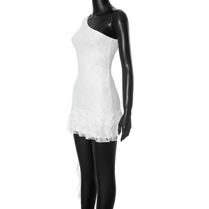 Close-up of white floral lace texture and double-layered ruffle hem on the mini dress