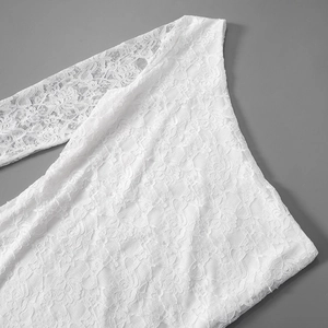 Detailed view of the one-shoulder white floral lace dress with delicate semi-transparent texture