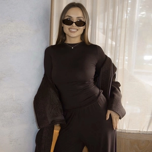 Detail of minimalist coffee brown three-piece set with long sleeve top and wide leg pants