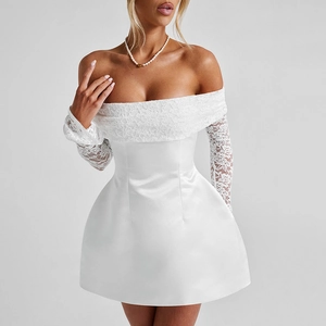Detail of the elegant white floral lace neckline and slim sleeves of the mini dress