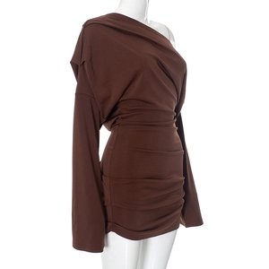 Detail of a brown one-shoulder long sleeve dress with ruched fabric on white background