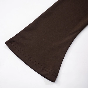 Close-up of dark brown knit fabric showing detailed double-needle hem and texture