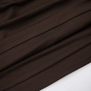 Macro shot of dark brown ribbed knit fabric texture on the off-shoulder mini dress