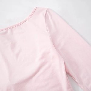 Detail view of the wide round neckline and stitching on a pink long sleeve knit shirt