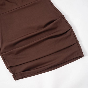 Detailed close-up of ruched side seams on a coffee brown long sleeve mini dress