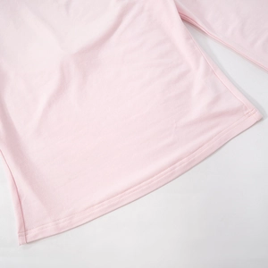 Close-up of light pink long sleeve top showing high-quality double-needle hem stitching