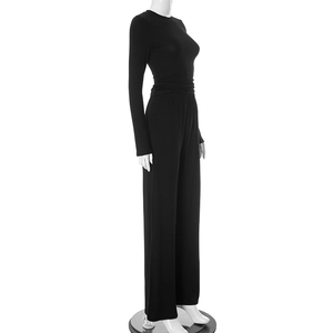 Side view of black long sleeve top and high waist wide leg pants set on mannequin