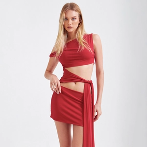 Sleeveless one-shoulder red mini dress with side cutout and crisscross tie details