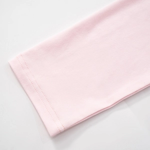 Detailed close-up of pink long sleeve cuff showing premium double-needle stitching quality