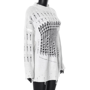 Close-up of distressed knit texture and ripped hollow-out details on a white sweater